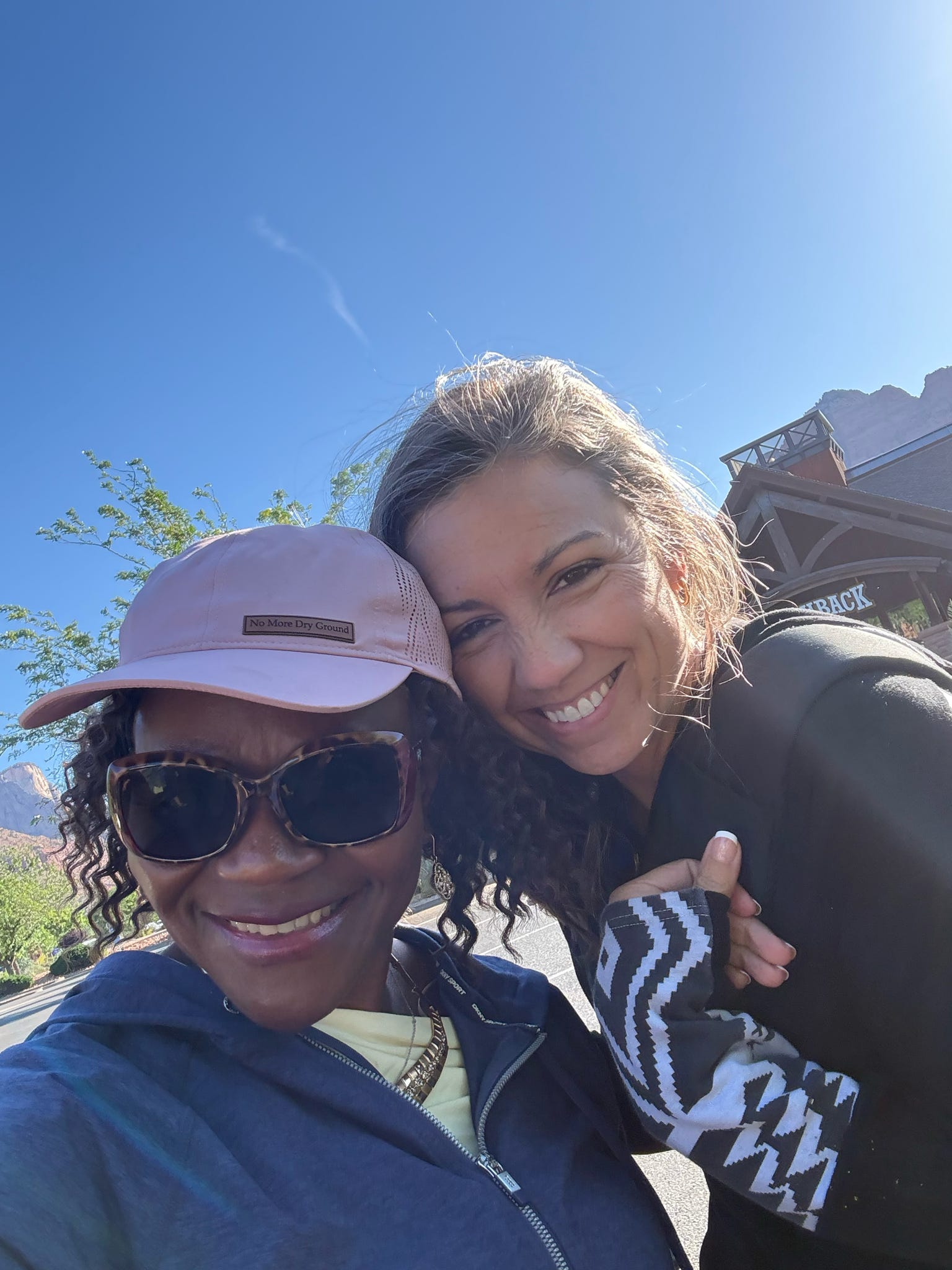 Two women smiling together during the No More Dry Ground Retreat excursion in Zion National Park.