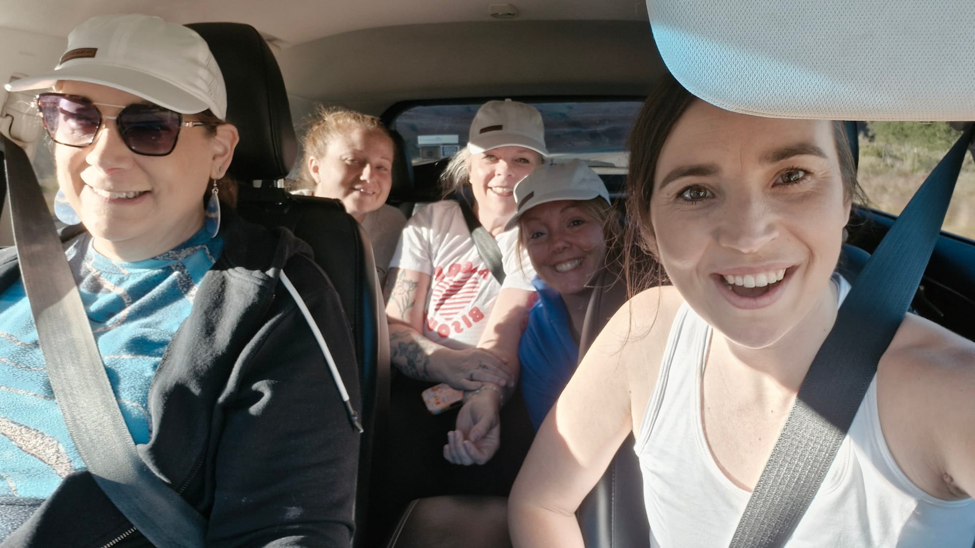 Women smiling together during transportation to The Narrows hike in Zion National Park.