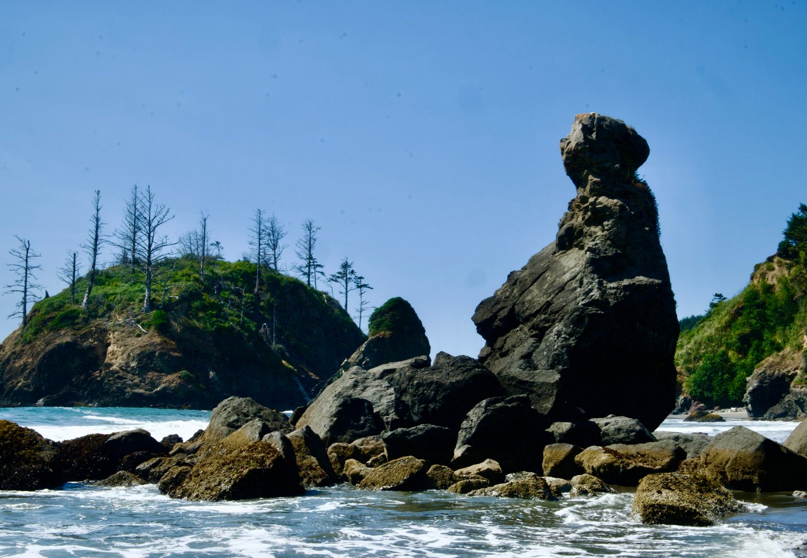 Towering sea stacks surrounded by ocean waves along the rocky coast near Klamath, California